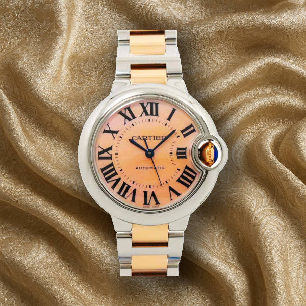 Cartier Ballon Bleu women’s dress watch – elegant round case with silver dial and blue sapphire crown, a 2025 style icon.